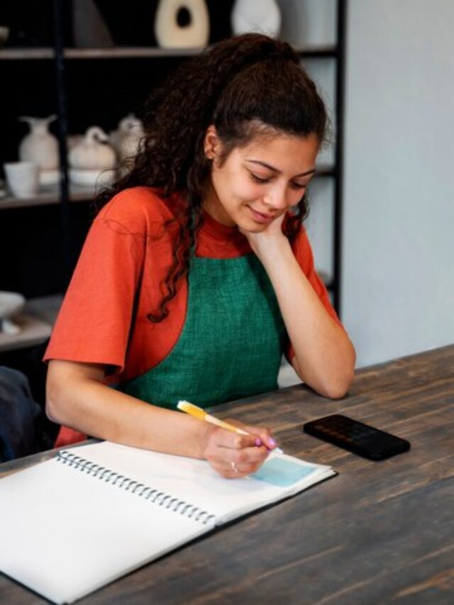 high-angle-woman-taking-notes_23-2149480209